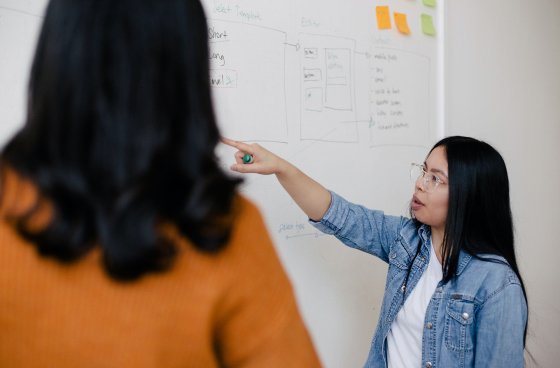 woman-pointing-at-whiteboard