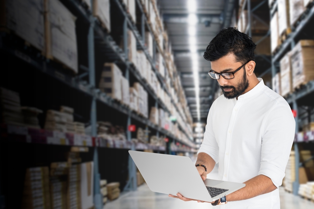 man in warehouse using laptop_supplychain_shutterstock_2595902665